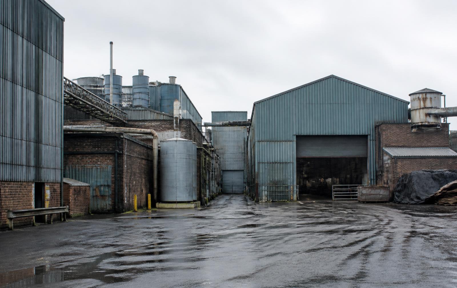 Contemporary tannery works with steel-clad buildings and wet yard